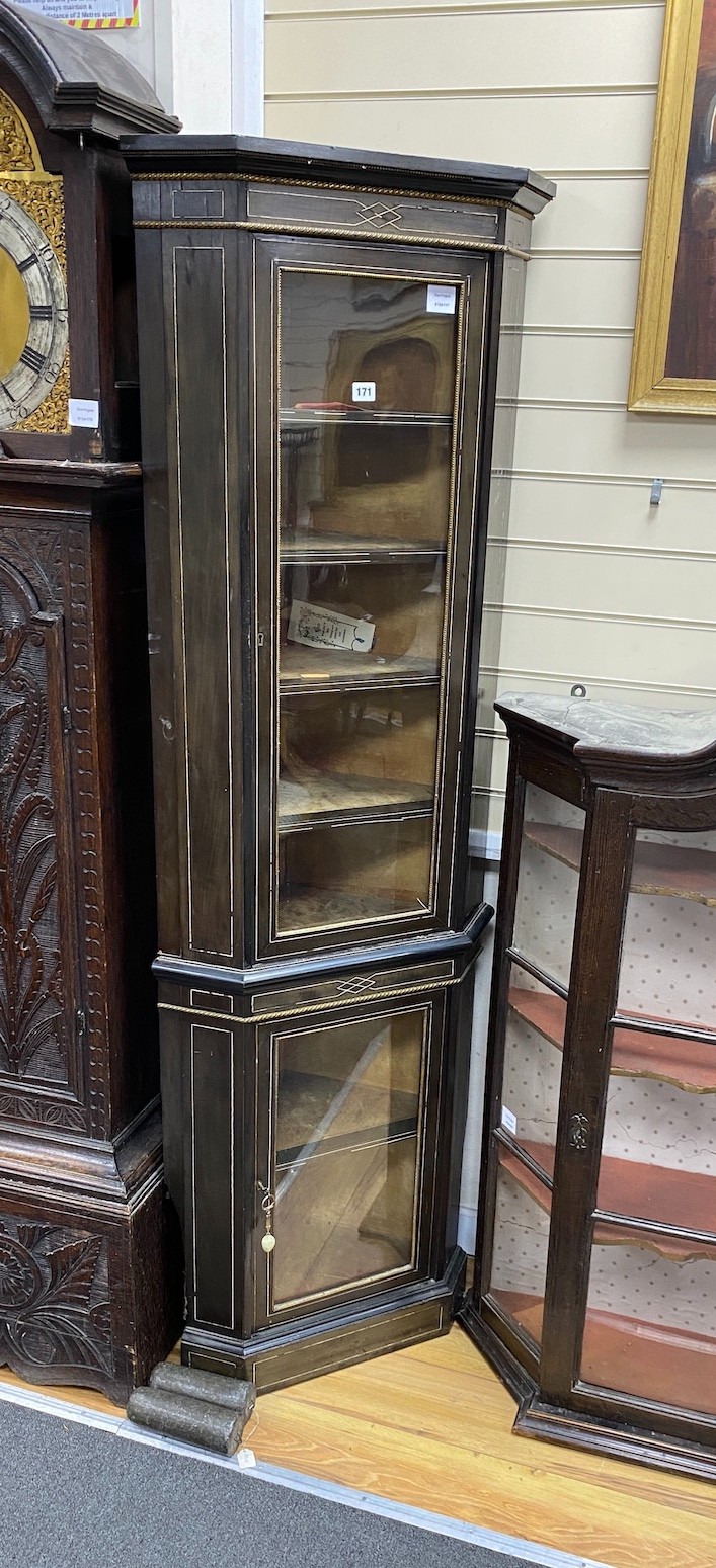 A late 19th century French ebonised two sectional glazed standing corner cabinet, width 61cm, depth 38cm, height 183cm